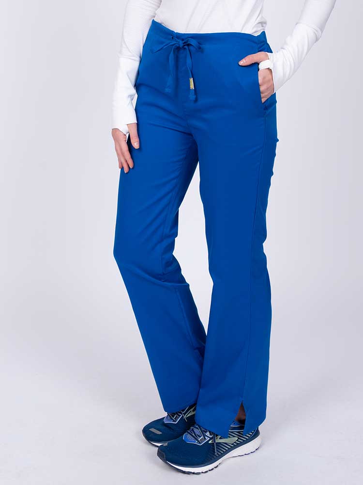 Nurse wearing an Epic by MedWorks Women's Drawstring Flare Leg Scrub Pant in royal with side slits for additional mobility.
