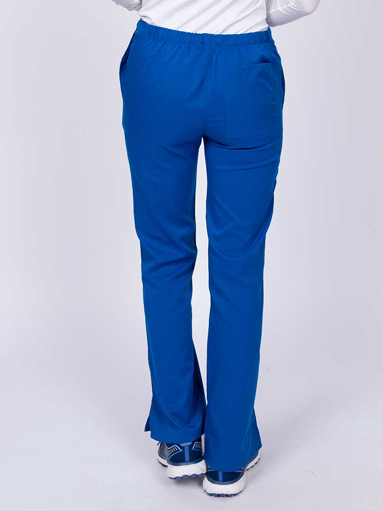 Young healthcare worker wearing an Epic by MedWorks Women's Drawstring Flare Leg Scrub Pant in royal featuring a drawstring waist with back elastic.