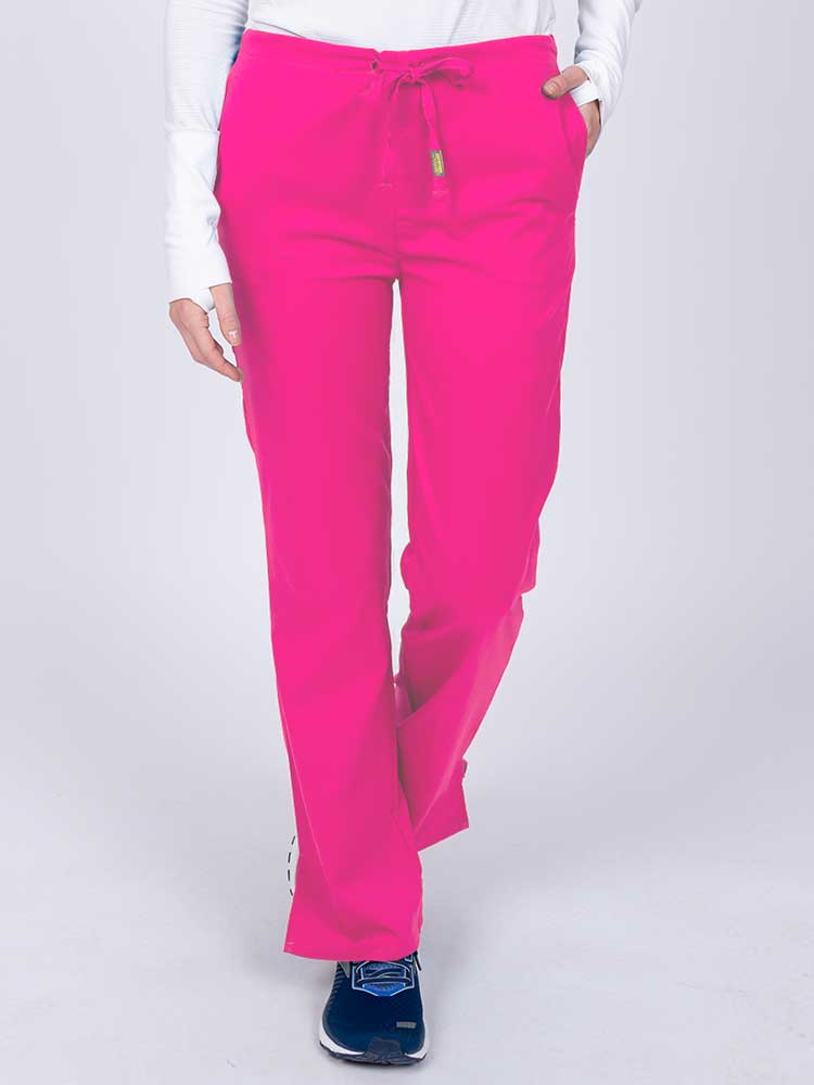 Young nurse wearing an Epic by MedWorks Women's Drawstring Flare Leg Scrub Pant in shocking pink with unique stretch fabric made of 77% Polyester, 21% Viscose, 2% Spandex.