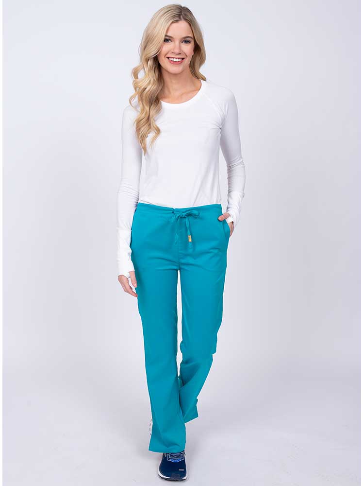Woman wearing an Epic by MedWorks Women's Drawstring Flare Leg Scrub Pant in teal with 2 front slash pockets & 1 back pocket.