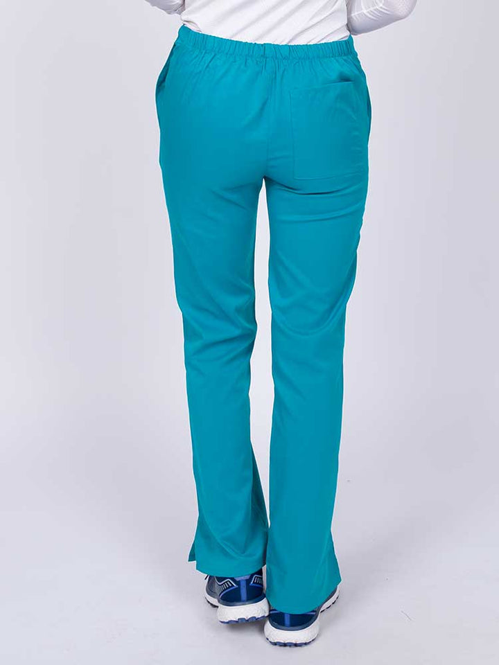 Young healthcare worker wearing an Epic by MedWorks Women's Drawstring Flare Leg Scrub Pant in teal featuring a drawstring waist with back elastic.