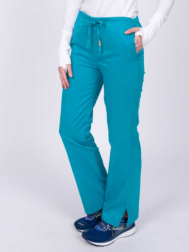 Nurse wearing an Epic by MedWorks Women's Drawstring Flare Leg Scrub Pant in teal with side slits for additional mobility.