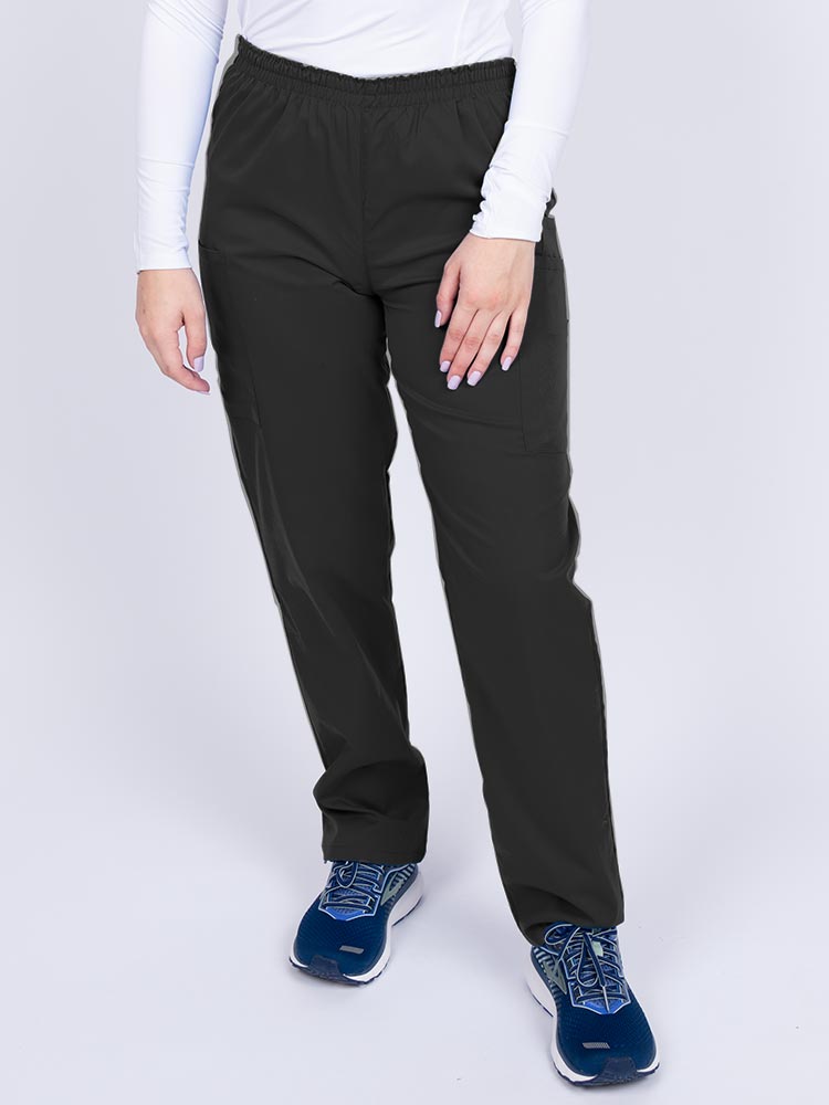 Young woman wearing an Epic by MedWorks Women's Elastic Waist Scrub Pant in black featuring a tapered leg and elastic waist.