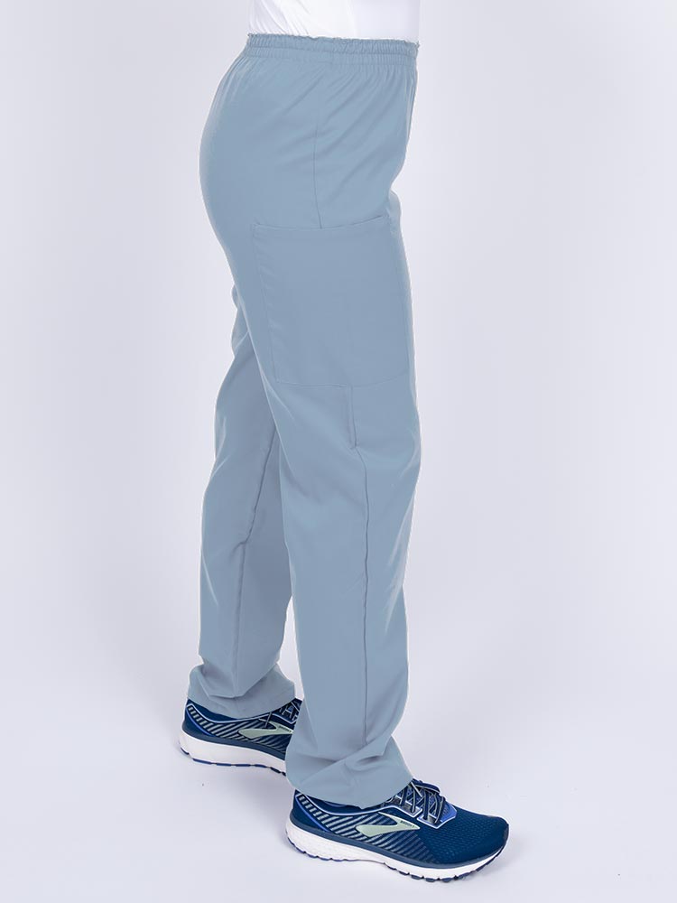 Woman wearing an Epic by MedWorks Women's Elastic Waist Scrub Pant in blue fog with two cargo pockets.