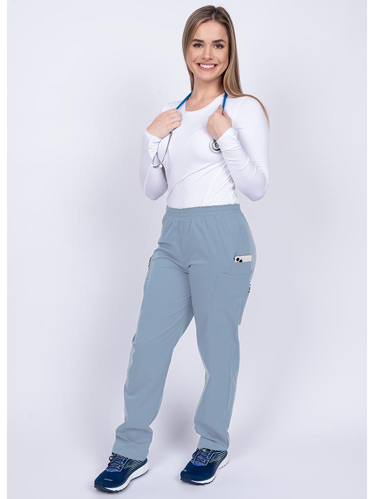 Healthcare worker wearing an Epic by MedWorks Women's Elastic Waist Scrub Pant in blue fog with 1 cell phone pocket & and 1 pen slot.
