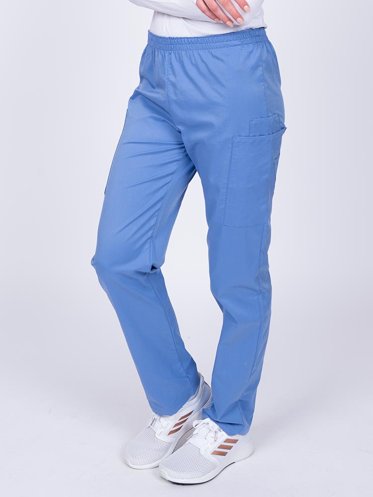 Woman wearing an Epic by MedWorks Women's Elastic Waist Scrub Pant in ceil with two cargo pockets.