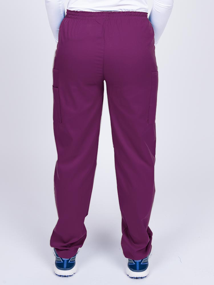 Nurse wearing an Epic by MedWorks Women's Elastic Waist Scrub Pant in eggplant with an innovative stretch fabric designed to move with you all day.