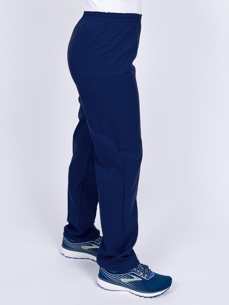 Woman wearing an Epic by MedWorks Women's Elastic Waist Scrub Pant in navy with two cargo pockets.