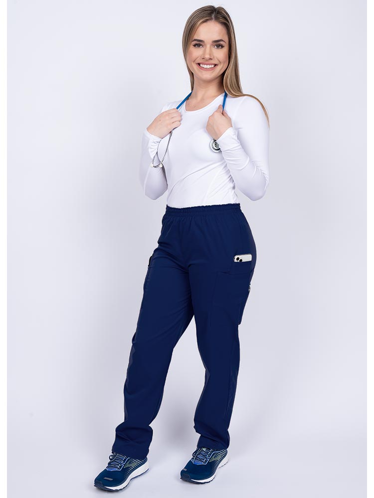 Healthcare worker wearing an Epic by MedWorks Women's Elastic Waist Scrub Pant in navy with 1 cell phone pocket & and 1 pen slot.