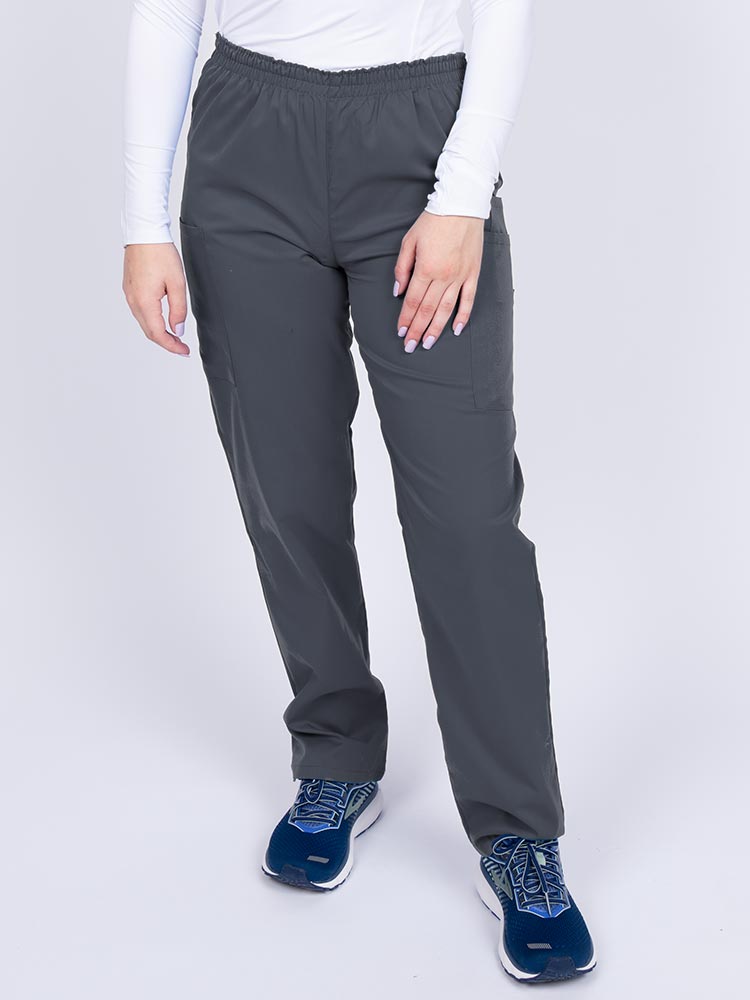 Young woman wearing an Epic by MedWorks Women's Elastic Waist Scrub Pant in pewter featuring a tapered leg and elastic waist.