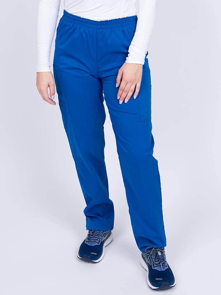 Young woman wearing an Epic by MedWorks Women's Elastic Waist Scrub Pant in royal featuring a tapered leg and elastic waist.