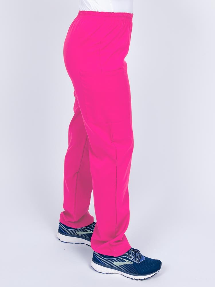 Woman wearing an Epic by MedWorks Women's Elastic Waist Scrub Pant in shocking pink with two cargo pockets.