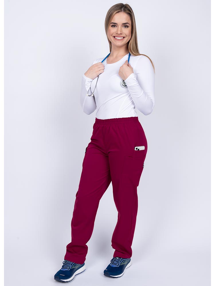 Healthcare worker wearing an Epic by MedWorks Women's Elastic Waist Scrub Pant in wine with 1 cell phone pocket & and 1 pen slot.