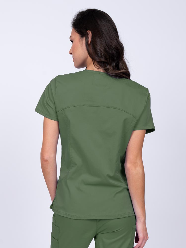 Young female nurse wearing an Epic by MedWorks Women's Knit Collar Mock Wrap Scrub Top in olive with stylish seaming throughout.