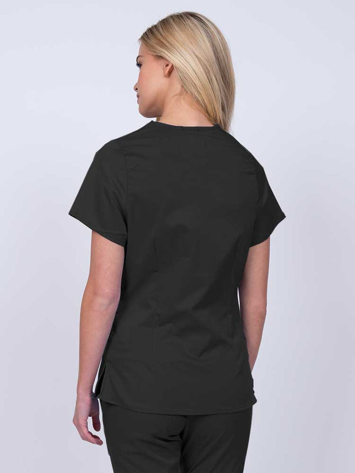 Nurse wearing an Epic by MedWorks Women's Mock Wrap Scrub Top in black with side slits for additional range of motion.