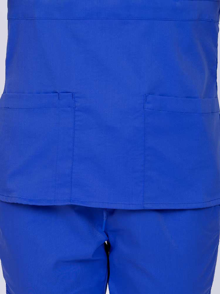Woman wearing an Epic by MedWorks Women's Mock Wrap Scrub Top in royal featuring two front patch pockets.