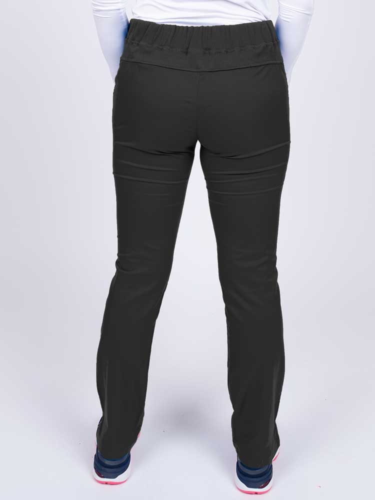 Nurse wearing an Epic by MedWorks Women's Blessed Skinny Yoga Scrub Pant in black with a knit waistband.