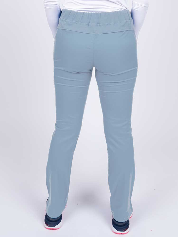 Nurse wearing an Epic by MedWorks Women's Blessed Skinny Yoga Scrub Pant in blue fog with a knit waistband.