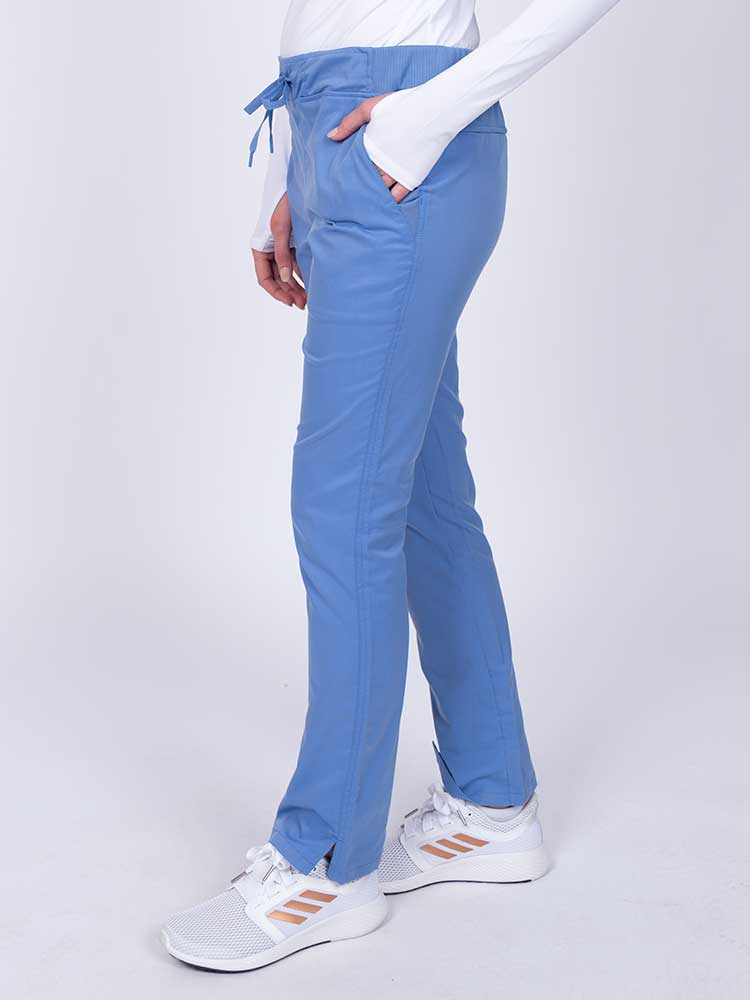 Nurse wearing an Epic by MedWorks Women's Blessed Skinny Yoga Scrub Pant in ceil with a knit waistband.