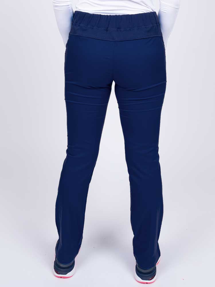 Nurse wearing an Epic by MedWorks Women's Blessed Skinny Yoga Scrub Pant in navy with a knit waistband.
