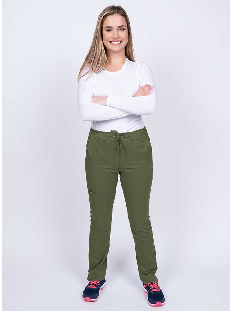 Young woman wearing an Epic by MedWorks Women's Blessed Skinny Yoga Scrub Pant in olive with an adjustable waistband.