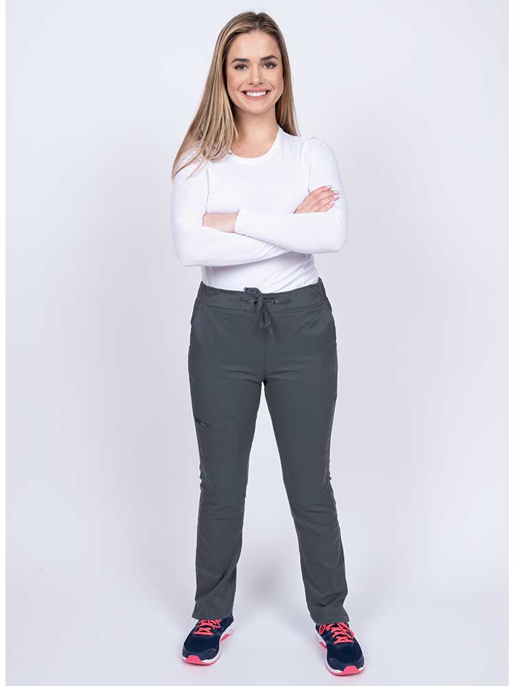 Young woman wearing an Epic by MedWorks Women's Blessed Skinny Yoga Scrub Pant in pewter with an adjustable waistband.