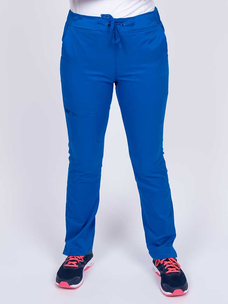Young healthcare worker wearing an Epic by MedWorks Women's Blessed Skinny Yoga Scrub Pant in royal featuring side slits for additional range of motion.