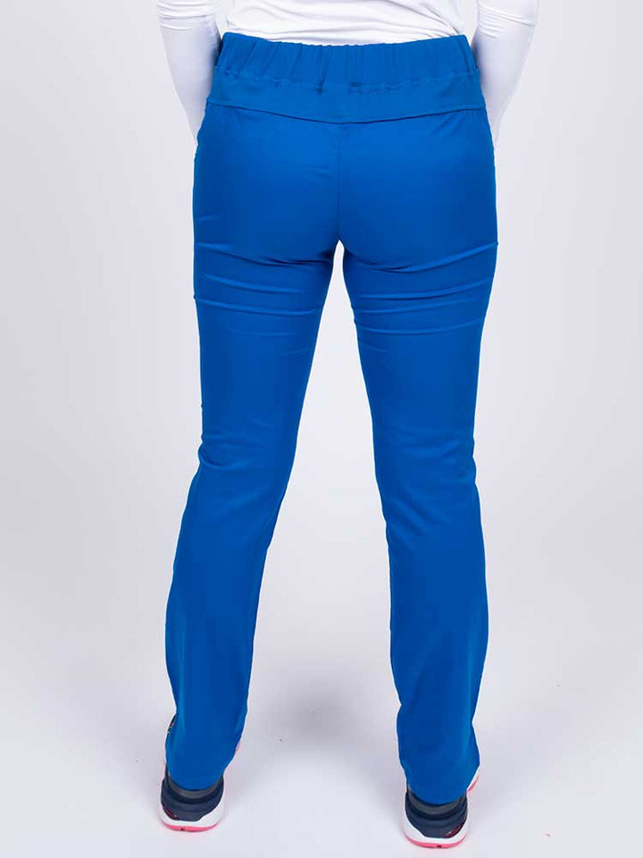 Nurse wearing an Epic by MedWorks Women's Blessed Skinny Yoga Scrub Pant in royal with a knit waistband.