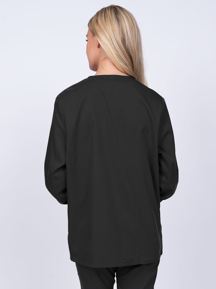 Young nurse wearing an Epic by MedWorks Women's Snap Front Scrub Jacket in black featuring a missy fit & a round neck.