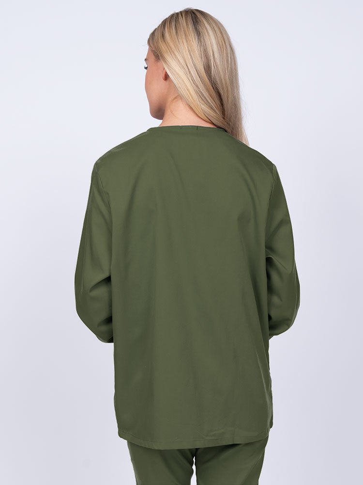 Young nurse wearing an Epic by MedWorks Women's Snap Front Scrub Jacket in olive featuring a missy fit & a round neck.