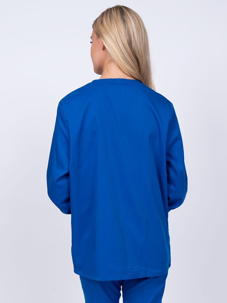Young nurse wearing an Epic by MedWorks Women's Snap Front Scrub Jacket in royal featuring a missy fit & a round neck.