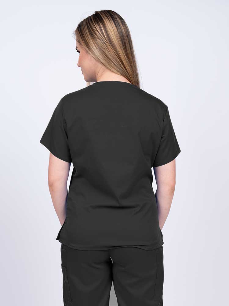 Woman wearing an Epic by MedWorks Women's Y-Neck Scrub Top in black with a center back length of 26".