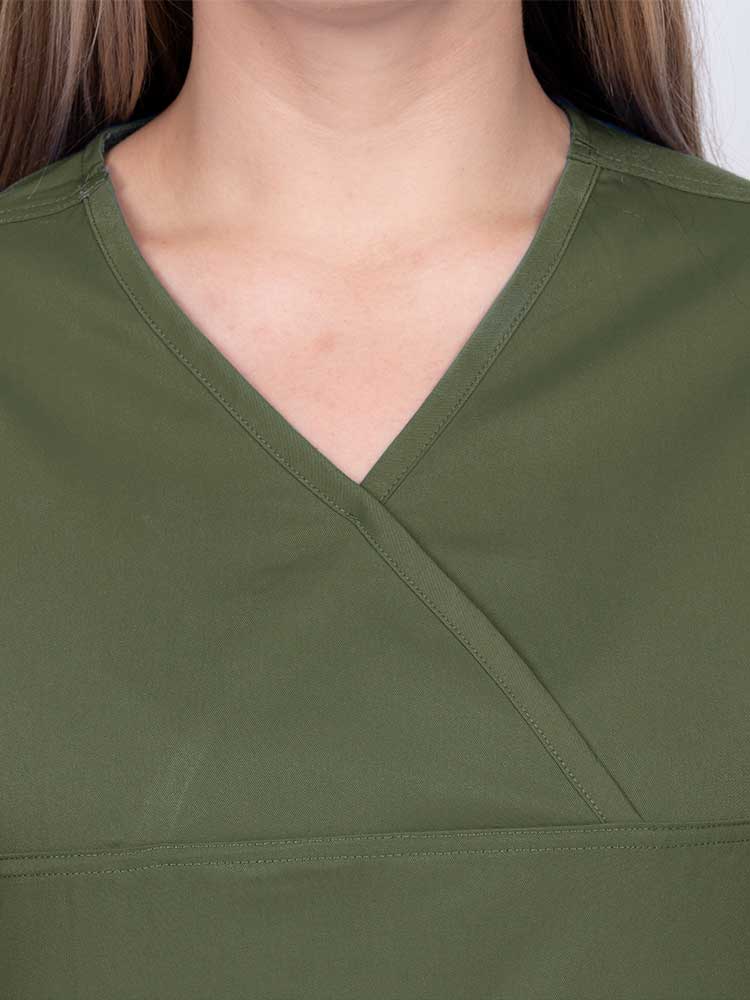 Woman wearing an Epic by MedWorks Women's Scrub Top in olive with a Y-neckline.