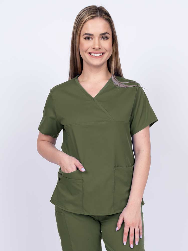 Woman wearing an Epic by MedWorks Women's Y-Neck Scrub Top in olive with a super soft, 2-way stretch fabric designed to move with your body all day long.