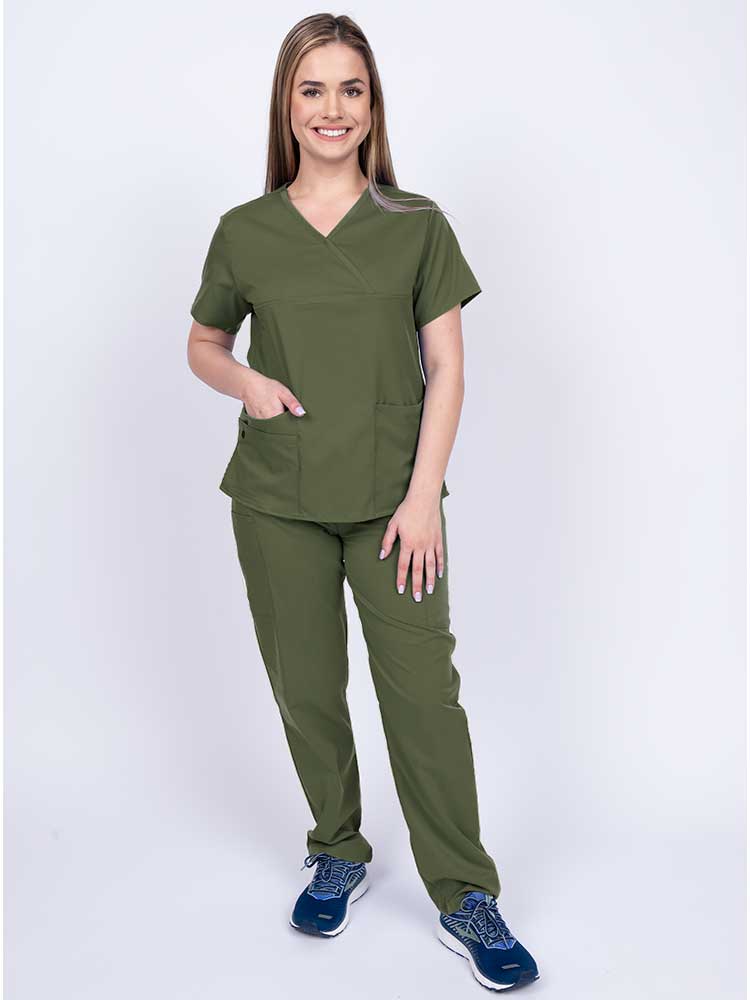Young woman wearing an Epic by MedWorks Women's Y-Neck Scrub Top in olive with 2 front patch pockets.