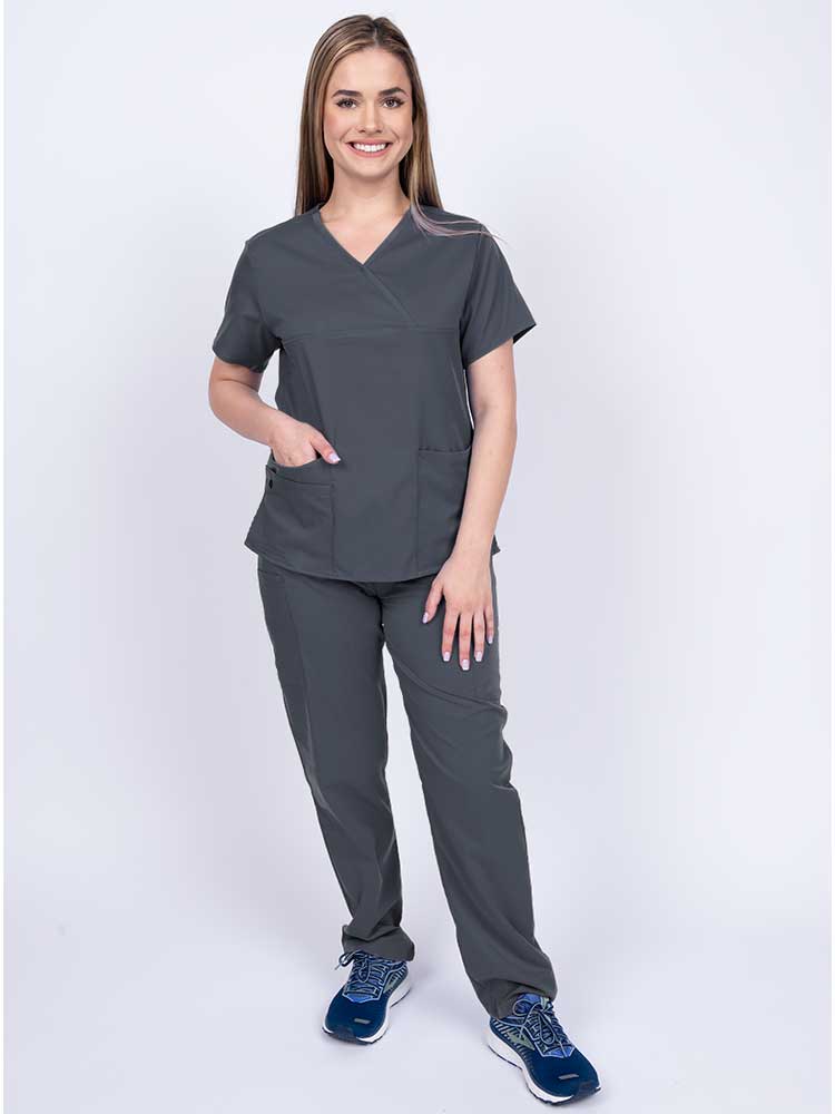 Young woman wearing an Epic by MedWorks Women's Y-Neck Scrub Top in pewter with 2 front patch pockets.