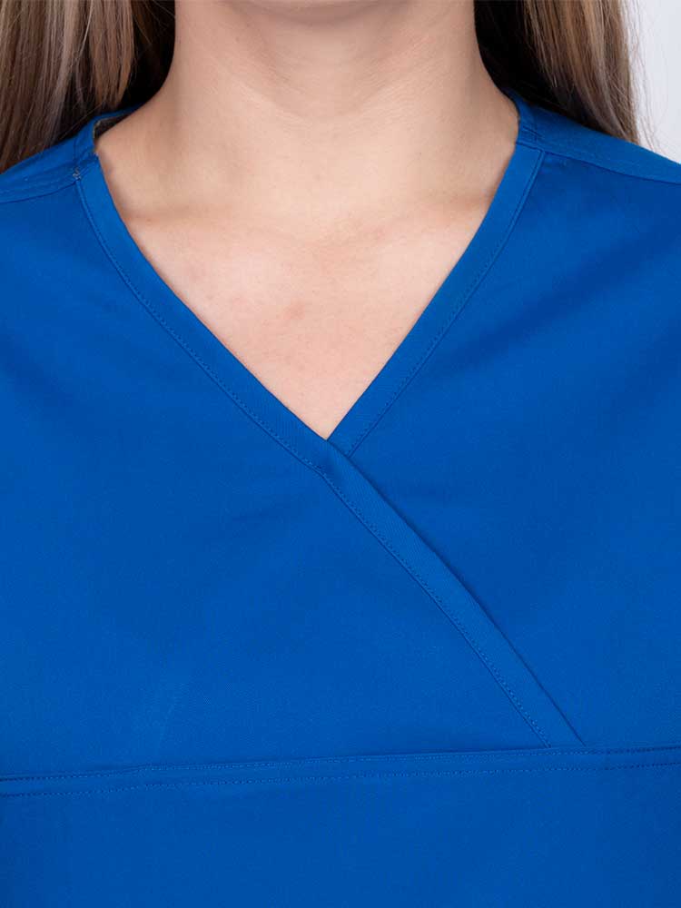 Woman wearing an Epic by MedWorks Women's Scrub Top in royal with a Y-neckline.