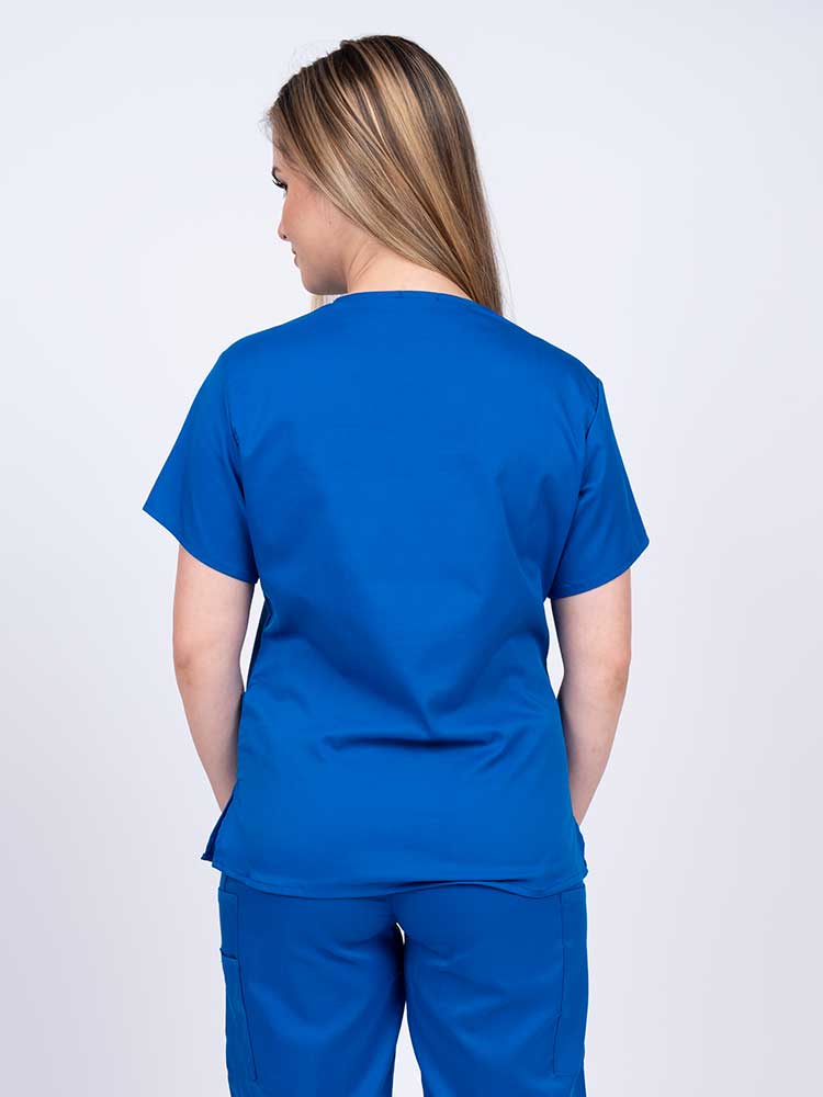Woman wearing an Epic by MedWorks Women's Y-Neck Scrub Top in royal with a center back length of 26".