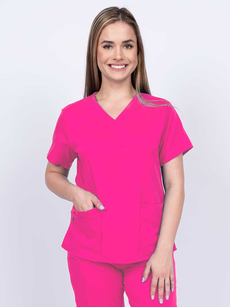 Woman wearing an Epic by MedWorks Women's Y-Neck Scrub Top in shocking pink with a super soft, 2-way stretch fabric designed to move with your body all day long.