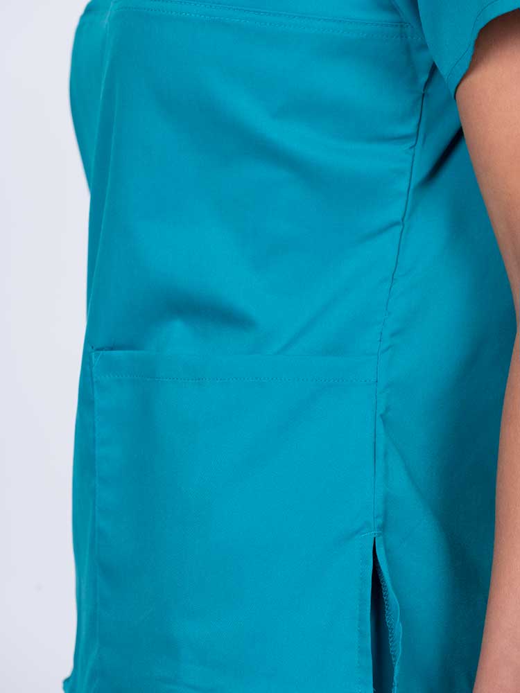Woman wearing an Epic by MedWorks Women's Scrub Top in teal with a Y-neckline.