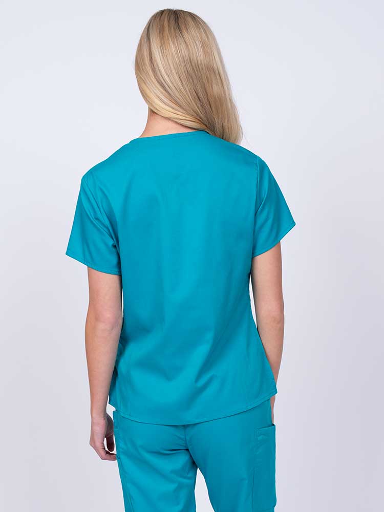 Woman wearing an Epic by MedWorks Women's Y-Neck Scrub Top in teal with a center back length of 26".