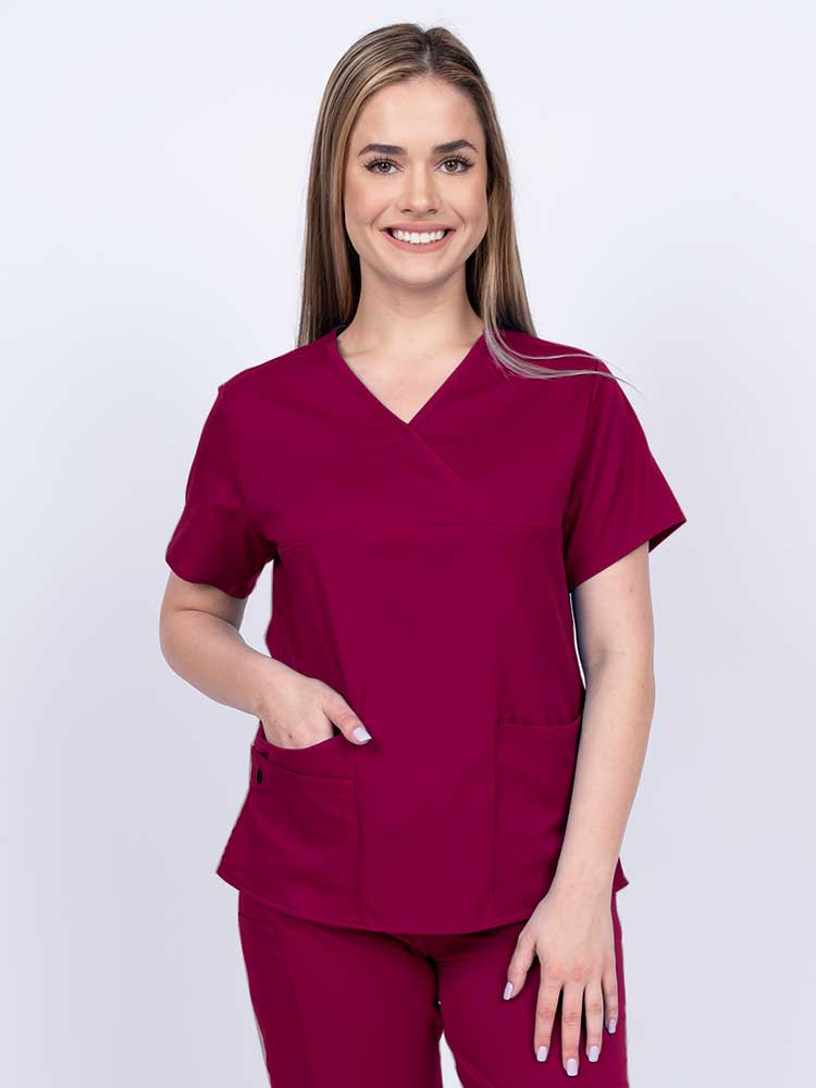 Woman wearing an Epic by MedWorks Women's Y-Neck Scrub Top in wine with a super soft, 2-way stretch fabric designed to move with your body all day long.