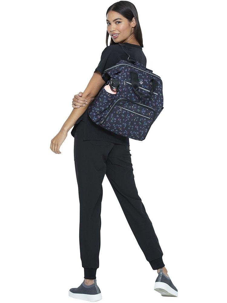 Nursing student carrying the HeartSoul Bella Backpack in All Awareness Ribbon print