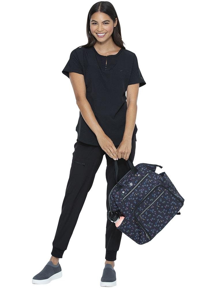 RN carrying the HeartSoul Bella Backpack in All Awareness Ribbon print featuring a padded tech pocket
