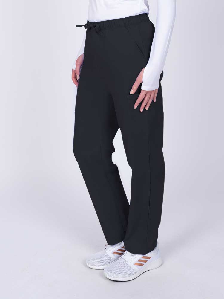 Woman wearing a Luv Scrubs by MedWorks Women's Elastic Waist Cargo Pant in black with 2 front slash pockets.