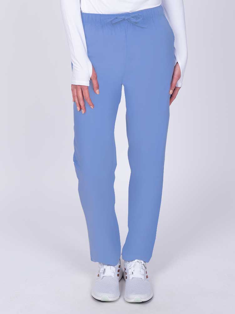 Young woman wearing a Luv Scrubs by MedWorks Women's Elastic Waist Cargo Pant in ceil featuring one cargo pocket on the wearer's left side.