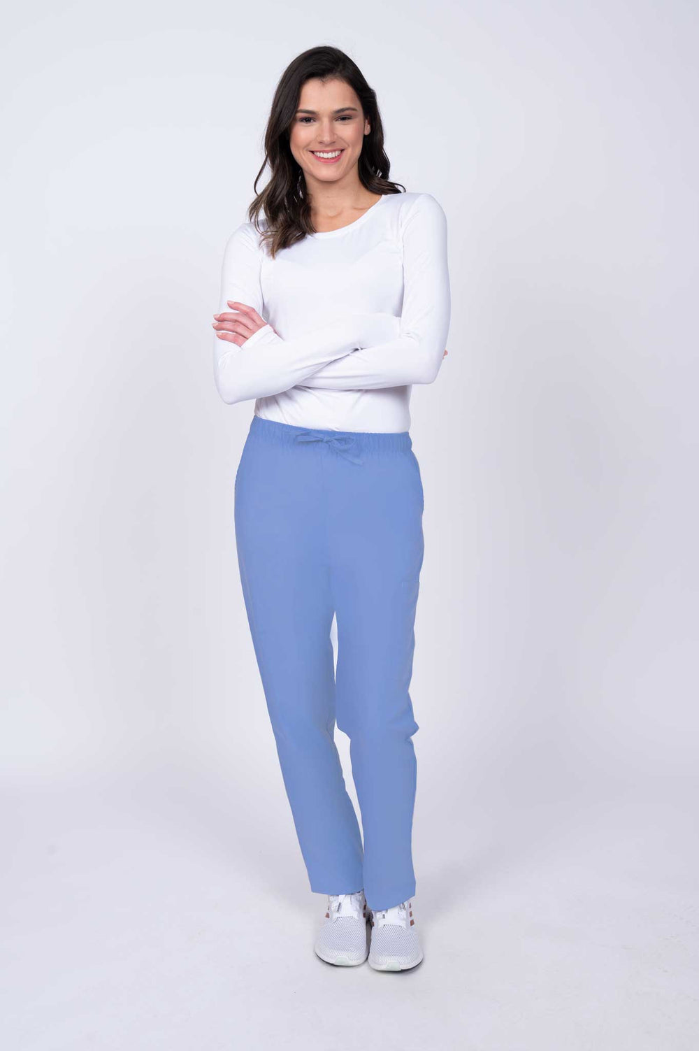Young healthcare worker wearing a Luv Scrubs by MedWorks Women's Elastic Waist Cargo Pant in ceil featuring a natural rise and straight legs.