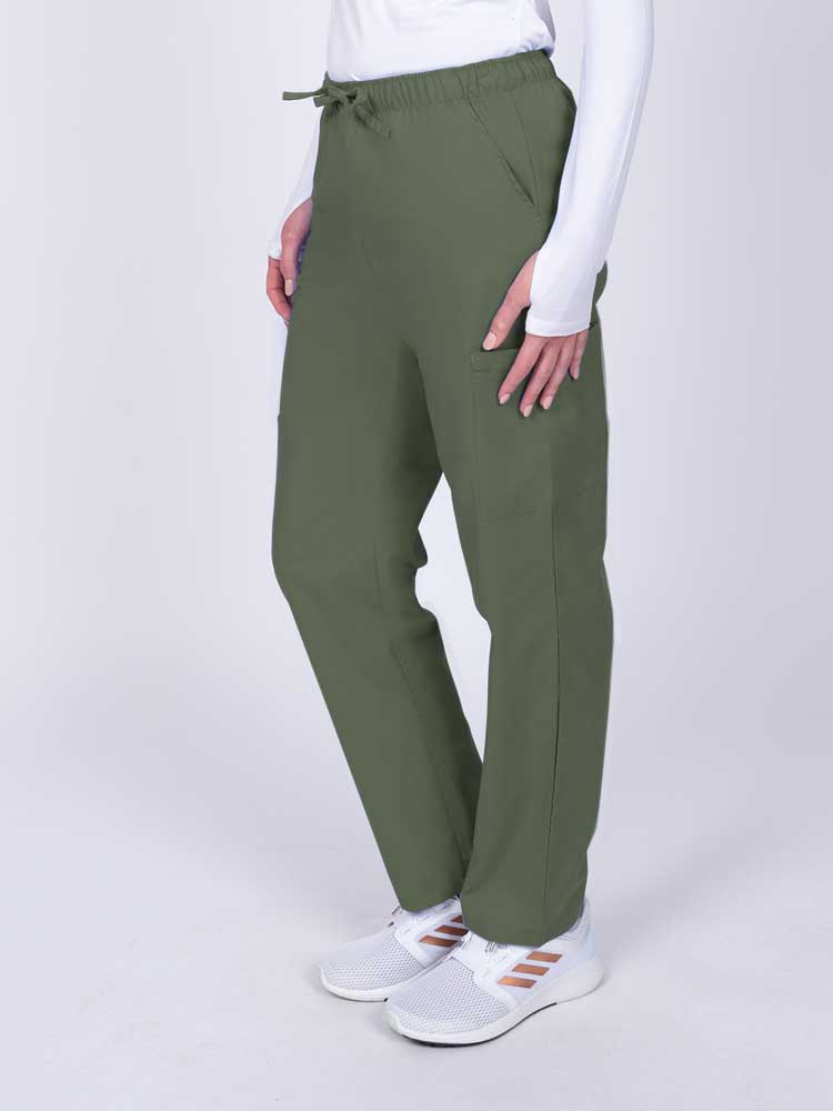 Woman wearing a Luv Scrubs by MedWorks Women's Elastic Waist Cargo Pant in olive with 2 front slash pockets.