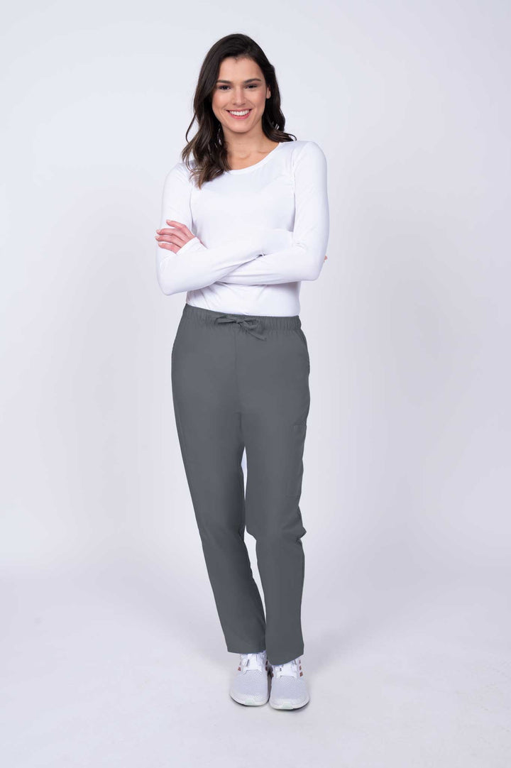 Young healthcare worker wearing a Luv Scrubs by MedWorks Women's Elastic Waist Cargo Pant in pewter featuring a natural rise and straight legs.