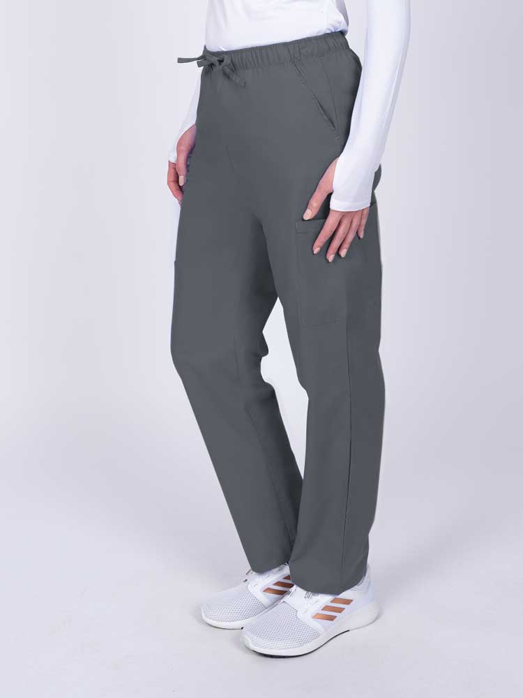 Woman wearing a Luv Scrubs by MedWorks Women's Elastic Waist Cargo Pant in pewter with 2 front slash pockets.